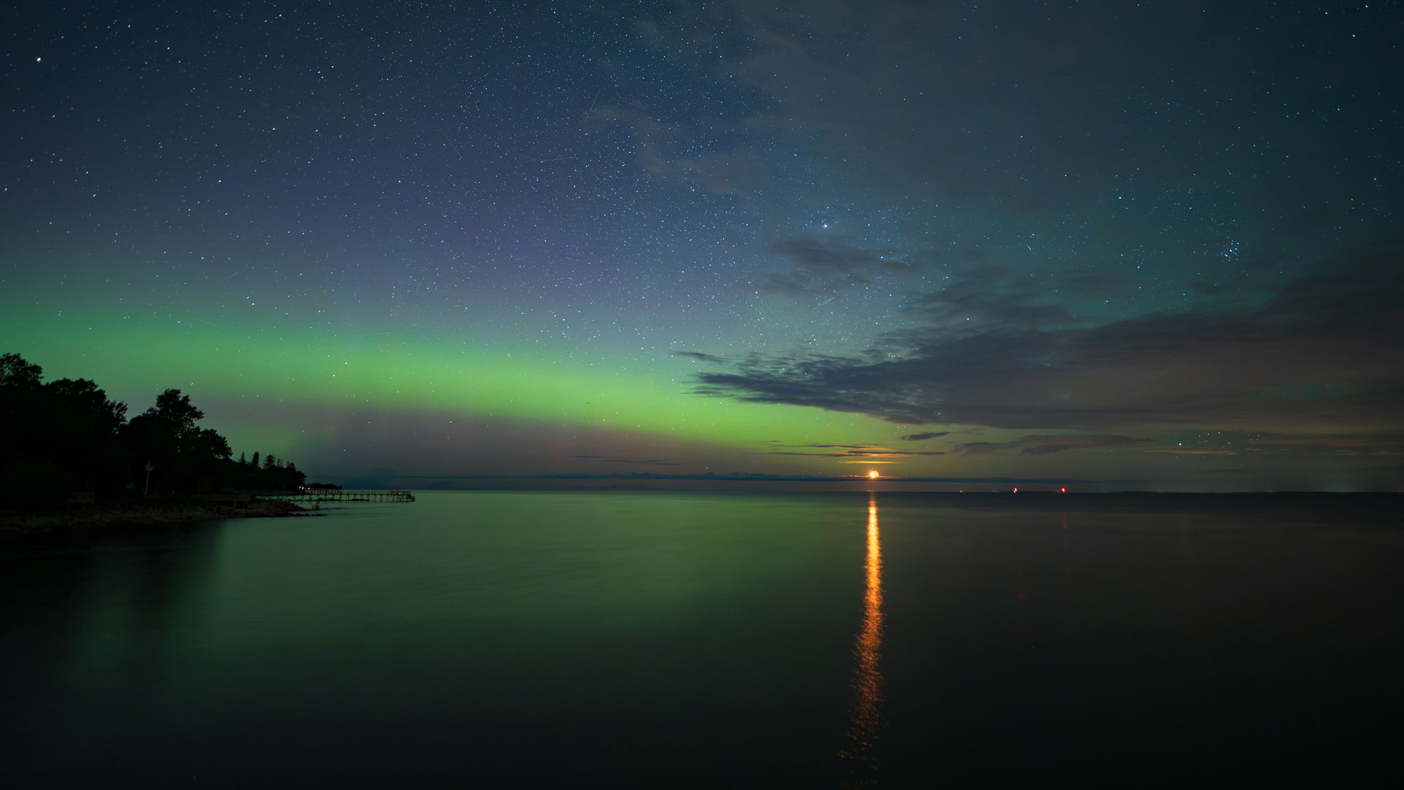 moon and aurora over lake winnipeg